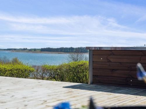 a wooden deck with a view of a body of water at Holiday Home Peetu - 200m to the fjord by Interhome in Doverodde