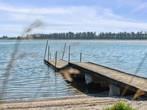 a dock in the middle of a large lake at Holiday Home Peetu - 200m to the fjord by Interhome in Doverodde