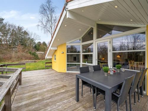 an outdoor patio with a black table and chairs at Holiday Home Sesto - 300m to the inlet by Interhome in Højslev