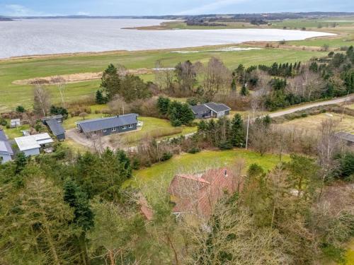 an aerial view of a house on a hill next to the water at Holiday Home Sesto - 300m to the inlet by Interhome in Højslev