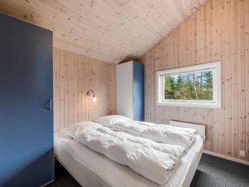 a bedroom with a bed in a room with a window at Holiday Home Sesto - 300m to the inlet by Interhome in Højslev