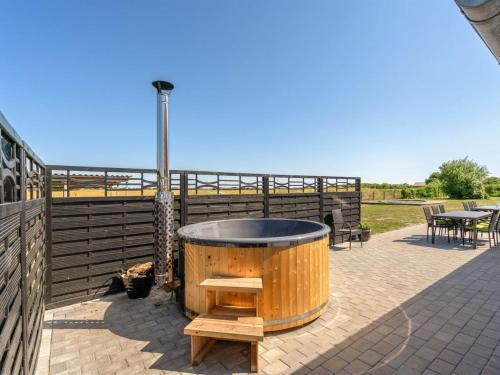 a hot tub on a patio next to a fence at Holiday Home Ailke - 2km to the fjord by Interhome in Thyholm
