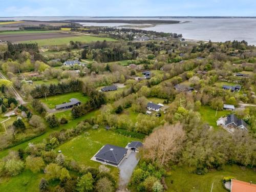 an aerial view of a subdivision with houses and the water at Holiday Home Veijo - 400m to the fjord by Interhome in Spottrup