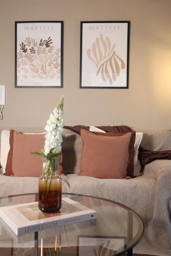 a living room with a couch and a glass table at Newcastle City Centre Apartment with Free Private Parking, Walk Away to Quayside in Newcastle upon Tyne