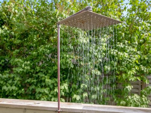 a bird bath with a shower in front of some trees at Holiday Home Eilke - 50m from the sea by Interhome in Rønde