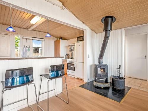 a kitchen with a stove in the middle of a room at Holiday Home Eilke - 50m from the sea by Interhome in Rønde