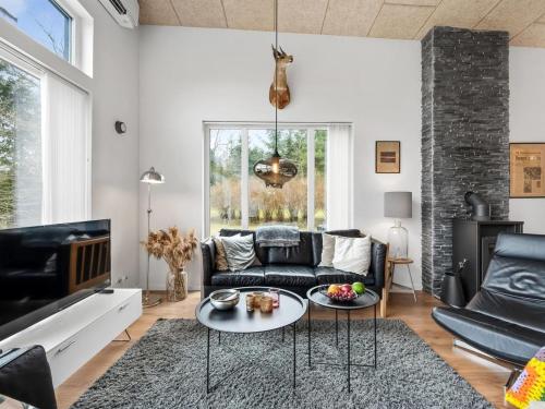 a living room with a couch and a table at Holiday Home Tenna - 250m to the fjord by Interhome in Højslev