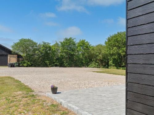 a gravel driveway with a potted plant on it at Holiday Home Markhild - 300m to the fjord by Interhome in Sønder Ydby