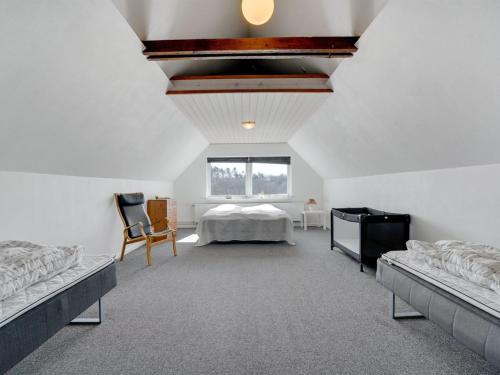 a bedroom with a bed and a window at Holiday Home Markhild - 300m to the fjord by Interhome in Sønder Ydby