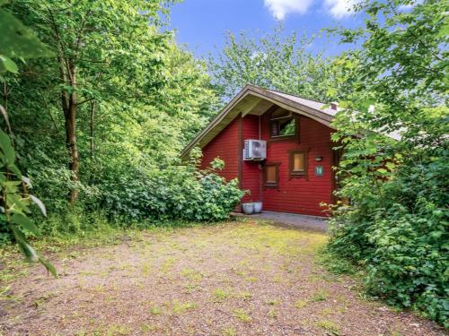 a red house in the middle of the woods at Holiday Home Andy - 500m to the fjord by Interhome in Spottrup