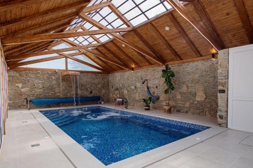 a large swimming pool in a room with a ceiling at ЕкоСадиба Пан Атаман in Skhidnitsa