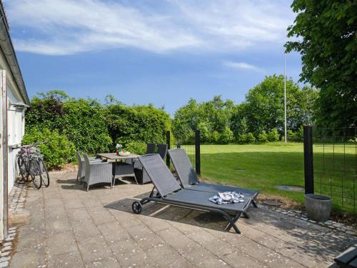 a patio with chairs and a table in a yard at Holiday Home Malinda - 500m from the sea by Interhome in Odder