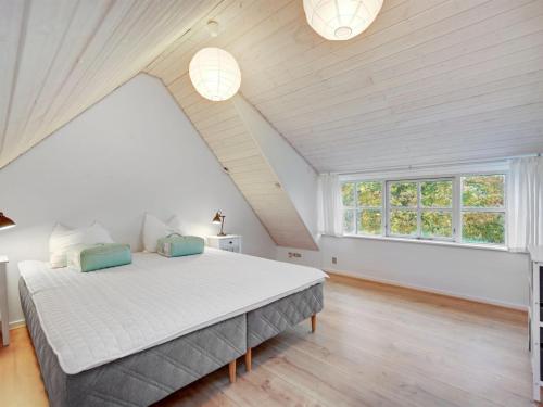 a bedroom with a large bed in a attic at Holiday Home Malinda - 500m from the sea by Interhome in Odder