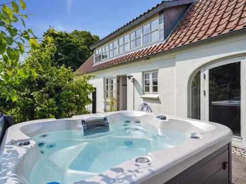 a bath tub in front of a house at Holiday Home Malinda - 500m from the sea by Interhome in Odder