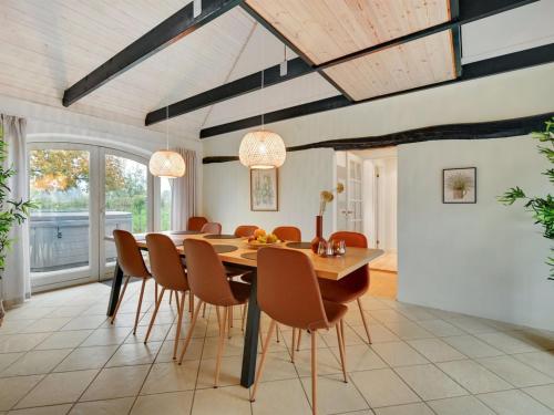 a dining room with a table and chairs at Holiday Home Malinda - 500m from the sea by Interhome in Odder