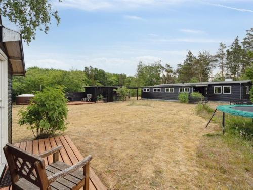 a yard with a bench and a house at Holiday Home Akke - 150m to the fjord by Interhome in Spottrup