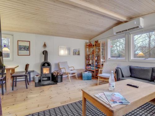 a living room with a wood stove in it at Holiday Home Akke - 150m to the fjord by Interhome in Spottrup
