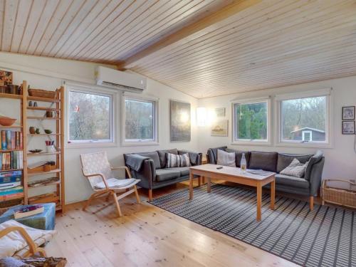 a living room with a couch and a table at Holiday Home Akke - 150m to the fjord by Interhome in Spottrup