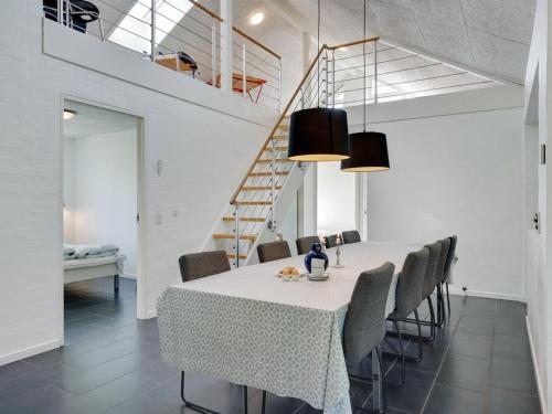 a dining room with a table and chairs at Holiday Home Aimy - 350m from the sea by Interhome in Grenå