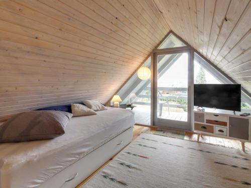 a bedroom with a bed and a large window at Holiday Home Ellenor - 300m to the inlet by Interhome in Højslev