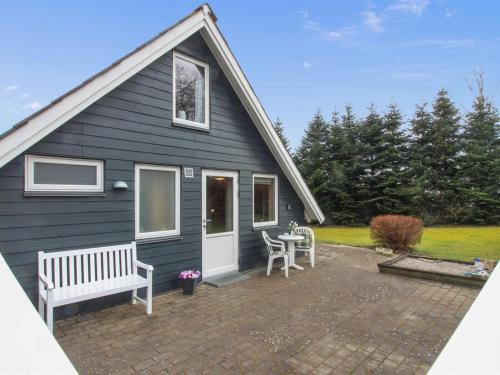 a blue house with a table and a bench at Holiday Home Ellenor - 300m to the inlet by Interhome in Højslev