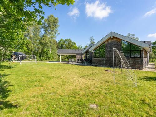a yard with a building and a soccer goal at Holiday Home Aimy - 350m from the sea by Interhome in Grenå
