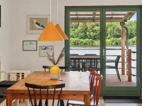 a dining room with a wooden table and chairs at Holiday Home Gertje by Interhome in Bryrup