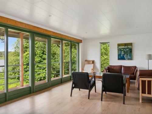 a living room with windows and a couch at Holiday Home Gertje by Interhome in Bryrup