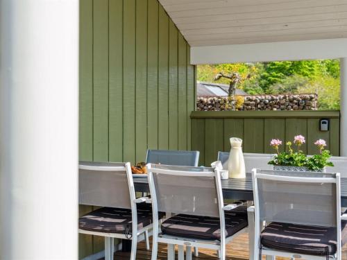 a dining room with a table and chairs at Holiday Home Henninge - 300m from the sea by Interhome in Brøndstrup