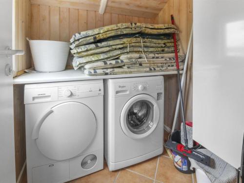 a laundry room with a washing machine and a washer at Holiday Home Pirkka - 50m to the inlet by Interhome in Løgstrup