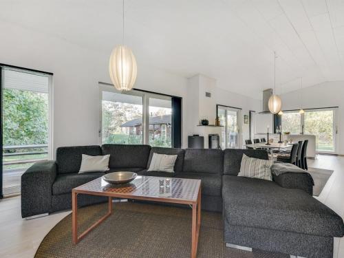 a living room with a couch and a table at Holiday Home Elfriede - 400m to the fjord by Interhome in Havndal