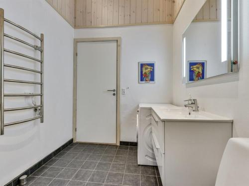 a bathroom with a sink and a washing machine at Holiday Home Nelie - 40km from the sea by Interhome in Silkeborg