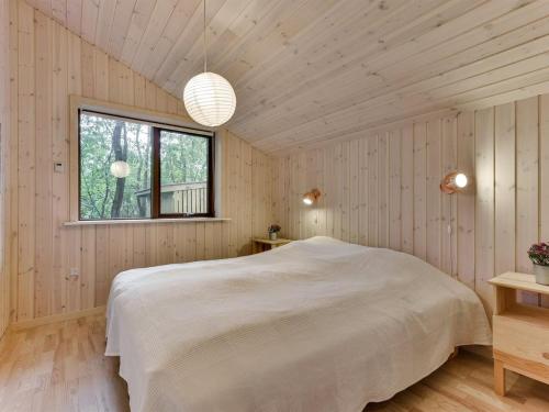 a bedroom with a white bed and a window at Holiday Home Nelie - 40km from the sea by Interhome in Silkeborg