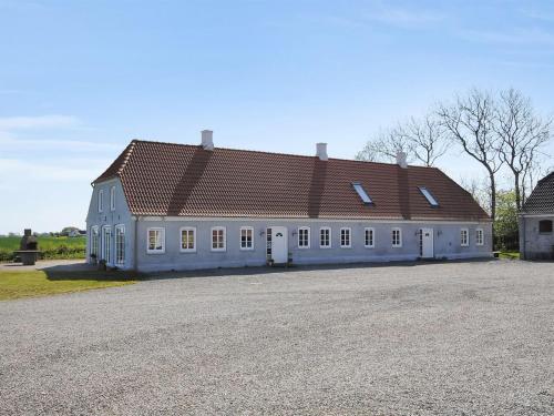a large white building with a brown roof at Holiday Home Alois - 1km to the fjord by Interhome in Hesselbjerg