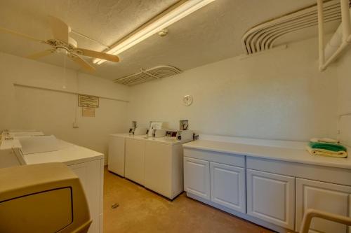 a kitchen with white cabinets and a ceiling fan at Vacation Villas #531 in Fort Myers Beach