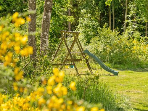 a green slide in the middle of a field at Holiday Home Gunward - 1-5km from the sea by Interhome in Sæby