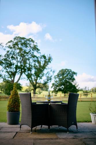two chairs and a table in a park at Green Grove Country House in Malham