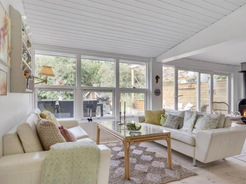 a living room with a white couch and a table at Holiday Home Jaana - 780m to the fjord by Interhome in Storvorde