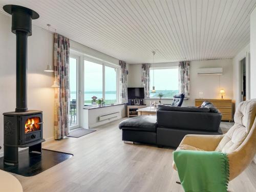 a living room with a fireplace and a couch at Holiday Home Ephra - 250m to the fjord by Interhome in Roslev