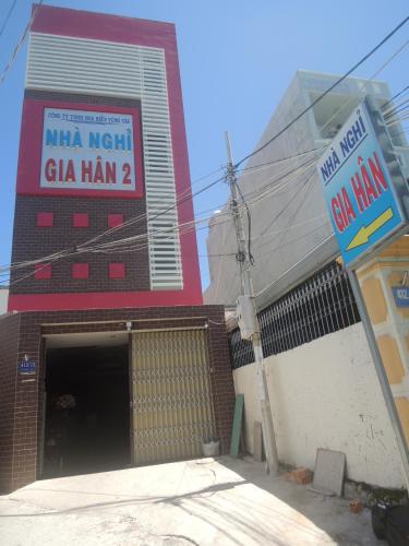 a building with a sign in front of a garage at Gia Han Guesthouse in Vung Tau
