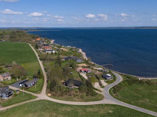 an aerial view of a house near the ocean at Holiday Home Elissa - 50m to the fjord by Interhome in Roslev