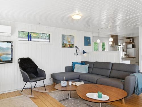 a living room with a couch and a table at Holiday Home Self - 400m to the fjord by Interhome in Løgstrup