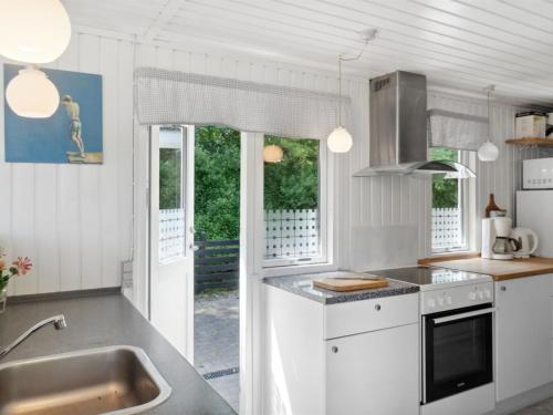 a kitchen with a sink and a counter top at Holiday Home Self - 400m to the fjord by Interhome in Løgstrup