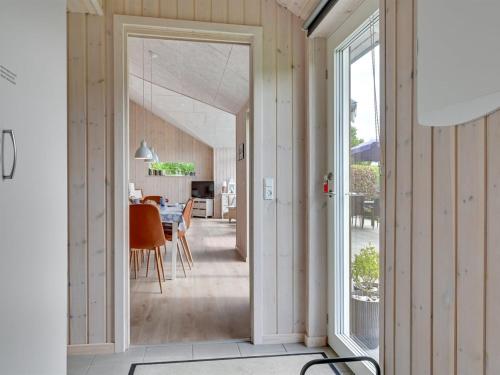 an open door to a dining room with a dining table at Holiday Home Regni - 300m to the inlet by Interhome in Nykøbing Mors