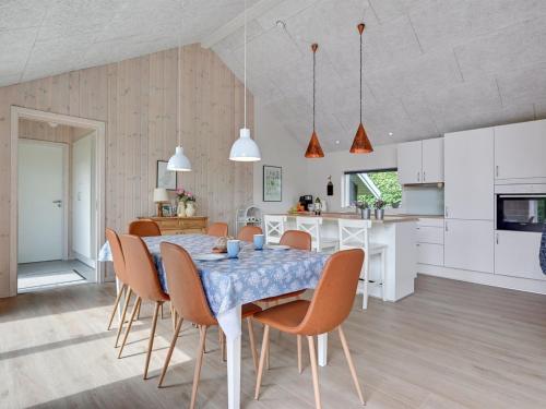 a kitchen and dining room with a table and chairs at Holiday Home Regni - 300m to the inlet by Interhome in Nykøbing Mors