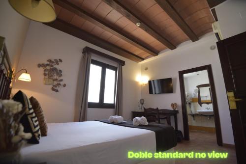 a bedroom with two beds and a large window at Hotel Boutique Cerro del Sol Adults only recommended in Granada