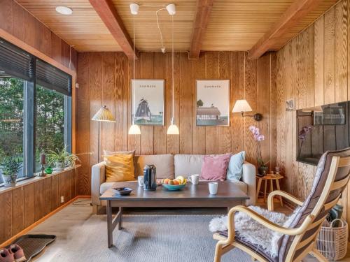 a living room with a couch and a table at Holiday Home Tayana - 75m to the inlet by Interhome in Storvorde