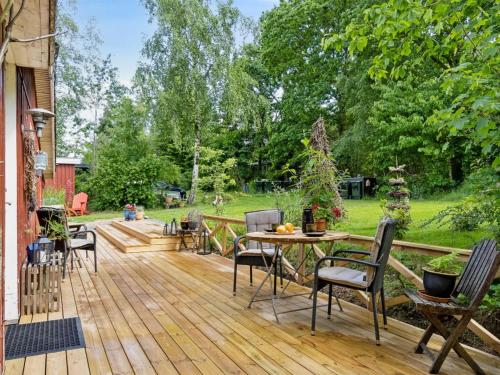 a wooden deck with a table and chairs on it at Holiday Home Reika - 1km from the sea by Interhome in Glesborg