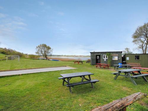 a group of picnic tables in a field at Holiday Home Imgert - 300m to the inlet by Interhome in Løgstrup