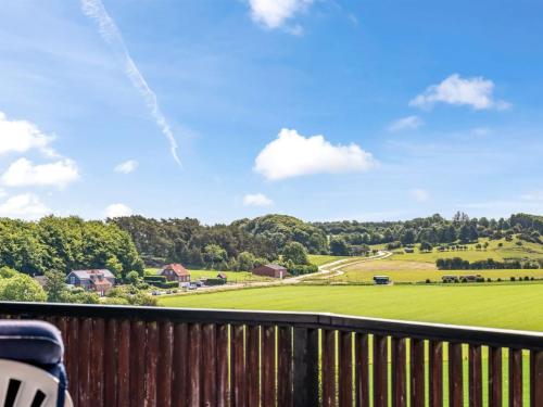 a balcony with a view of a green field at Holiday Home Imgert - 300m to the inlet by Interhome in Løgstrup